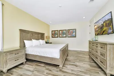 a bedroom with a large bed and two dressers at Peachy Dream Cottage With Private Pool Near Disney And Margaritaville Resort &Land H2O Access - 8016Kd in Orlando