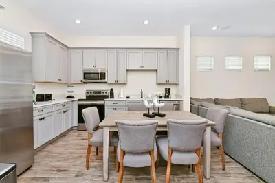 a kitchen and dining room with a table and chairs at Inviting Cottage With Private Pool Near Disney With Margaritaville Resort & Island H2O Access - 8022Kd in Orlando