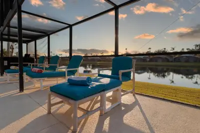 a group of chairs sitting on top of a building at Sunny South Facing Pool with Hot Tub and Lake View Near Disney in Kissimmee