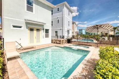 a swimming pool in front of a house at Sunset Dream Cottage With Private Pool Near Disney With Margaritaville Resort & Island H2O Access - 8029Kd in Orlando