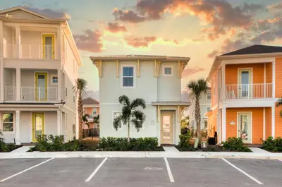 a row of houses with palm trees in a parking lot at Sunset Dream Cottage With Private Pool Near Disney With Margaritaville Resort & Island H2O Access - 8029Kd in Orlando