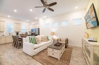 a living room with a white couch and a table at Sunset Dream Cottage With Private Pool Near Disney With Margaritaville Resort & Island H2O Access - 8029Kd in Orlando