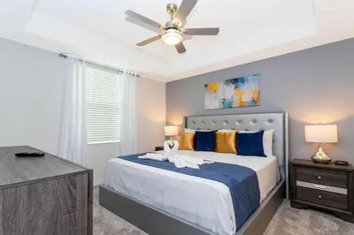 a bedroom with a bed with a ceiling fan at Stunning 2 Bedroom Apartment Close to Disney 304 3191 in Kissimmee