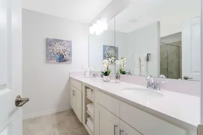 a bathroom with two sinks and a large mirror at Stunning 2 Bedroom Apartment Close to Disney 304 3191 in Kissimmee