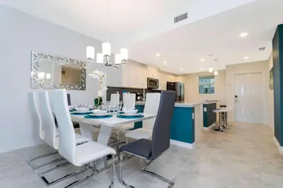 a kitchen and dining room with a table and chairs at Gorgeous 2 Bedroom Apartment Close to Disney 305 31911 in Kissimmee