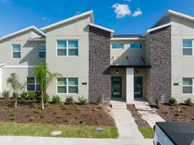 a house with a landscaping in front of it at Gorgeous 4 Bd w/ Pool Close to Disney @ Storey Lake 2963 in Kissimmee