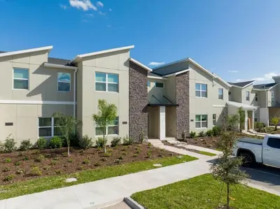 a house with a car parked in front of it at Gorgeous 4 Bd w/ Pool Close to Disney @ Storey Lake 2963 in Kissimmee