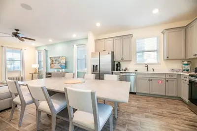 a kitchen with a table and chairs in a room at Vibrant Cottage With Private Pool Near Disney With Margaritaville Resort & Island H2O Access - 8031Kd in Orlando