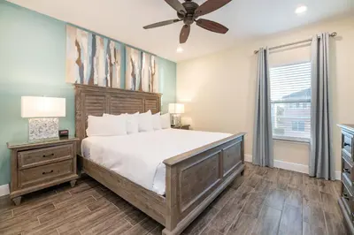 a bedroom with a large bed and a ceiling fan at Vibrant Cottage With Private Pool Near Disney With Margaritaville Resort & Island H2O Access - 8031Kd in Orlando