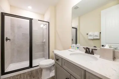 a bathroom with a shower and a toilet and a sink at Vibrant Cottage With Private Pool Near Disney With Margaritaville Resort & Island H2O Access - 8031Kd in Orlando