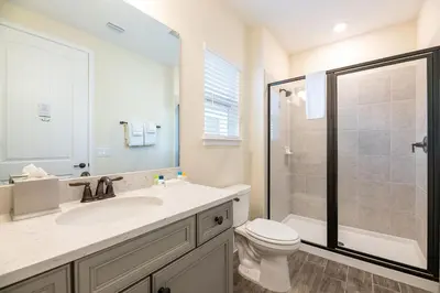 a bathroom with a sink and a toilet and a shower at Vibrant Cottage With Private Pool Near Disney With Margaritaville Resort & Island H2O Access - 8031Kd in Orlando