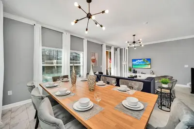 a dining room and living room with a table and chairs at 4200 Paragraph Drive in Kissimmee