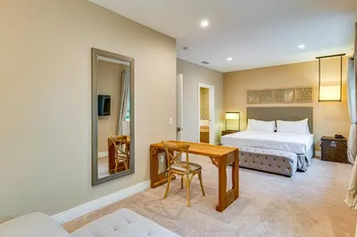a bedroom with a bed and a desk with a table at Magic Villas Townhome about 5 Mi to Disney Parks! in Orlando