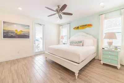 a bedroom with a bed and a ceiling fan at Sunburnt Cottage With Hot Tub Near Disney With Margaritaville Resort & Island H2O Access - 8041Sh in Orlando