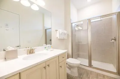 a bathroom with a toilet and a sink and a shower at Inviting Cottage With Private Hot Tub Near Disney With Margaritaville Resort & Island H2O Access - 8072Dr in Orlando