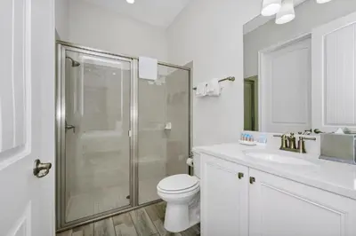a bathroom with a shower and a toilet and a sink at Dreamy Cottage With Private Pool Near Disney With Margaritaville Resort & Island H2O Access - 8082Kd in Orlando