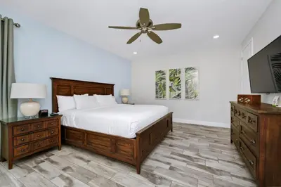 a bedroom with a bed and a ceiling fan at Dreamy Cottage With Private Pool Near Disney With Margaritaville Resort & Island H2O Access - 8082Kd in Orlando