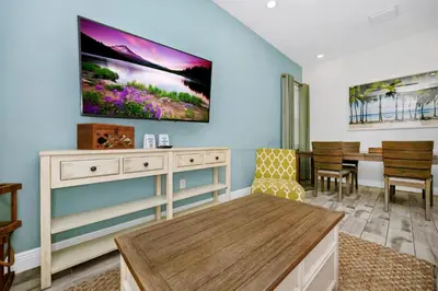 a living room with a tv on the wall at Dreamy Cottage With Private Pool Near Disney With Margaritaville Resort & Island H2O Access - 8082Kd in Orlando