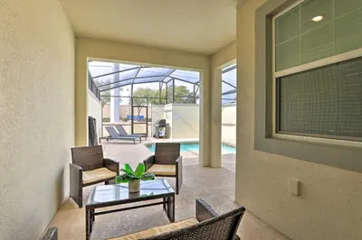 a living room with a table and chairs at 5 Mi to Disney Chic Townhome with Community Perks! in Kissimmee