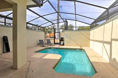 a swimming pool in the middle of a house at 5 Mi to Disney Chic Townhome with Community Perks! in Kissimmee