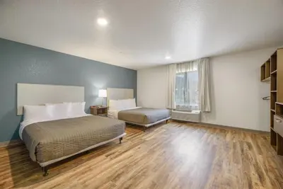 a hotel room with a bed and a window at WoodSpring Suites Orlando I-4 & Convention Center in Orlando
