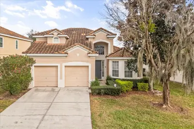 a house with a driveway and a garage at Disney Vacation Oasis Pool BBQ Resort Fun in Orlando