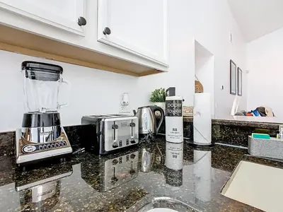 a kitchen counter with a blender on top of it at Casita mi Encanto a Cozy & Spacious House, 4-bedroom 3-Bath & pool in Kissimmee