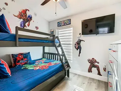 a bedroom with two bunk beds with superhero wall decals at Casita mi Encanto a Cozy & Spacious House, 4-bedroom 3-Bath & pool in Kissimmee