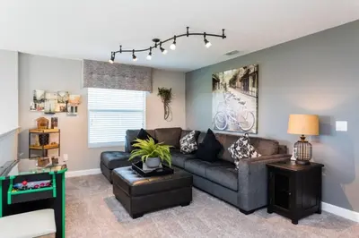 a living room with a couch and a table at 5 bedroom home is ideal for an elegant vacation villa in Kissimmee
