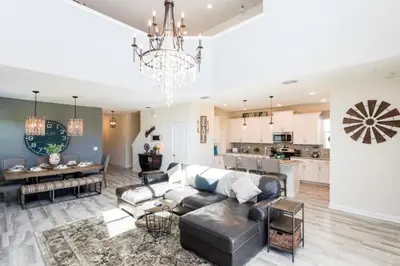 a living room with a couch and a table at 5 bedroom home is ideal for an elegant vacation villa in Kissimmee