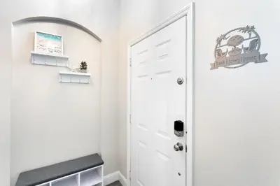 a hallway with a white door and a shelf at Amazing 6 Bed Disney Dream Getaway in Windsor Palm villa in Kissimmee
