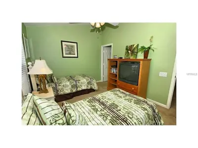 a hotel room with two beds and a television at 3 Bedroom,3 Bath Townhouse in Gate Resort townhouse in Kissimmee