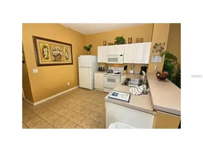 a kitchen with white appliances and yellow walls at 3 Bedroom,3 Bath Townhouse in Gate Resort townhouse in Kissimmee