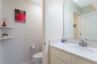 a bathroom with a sink and a toilet and a mirror at Stunning 2Bd Apto Close to Disney @ Storey Lake 105P 3171 in Kissimmee