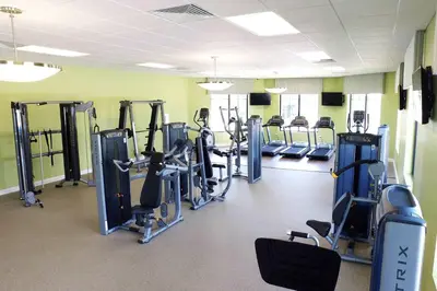 a gym with rows of treadmills and machines at Stunning 2Bd Apto Close to Disney @ Storey Lake 105P 3171 in Kissimmee
