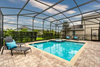 a swimming pool with a pergola next to a house at Encore Resort 6 Bedroom Home with Pool 2300 in Orlando