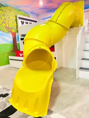 a yellow inflatable slide in a play room at Happiest House on Earth near Disney World 9 Bedroom, Pool, Theater, Gameroom, Mickey Bunk room with Twisty Slide in Storey Lake in Kissimmee