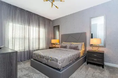a bedroom with a bed and a large window at Gorgeous 4 Bd Close to Disney w/ Pool @ Storey Lake Resort 4245 in Kissimmee