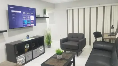 a living room with two chairs and a tv at 3697 Orlando Vacational Apartment in Orlando
