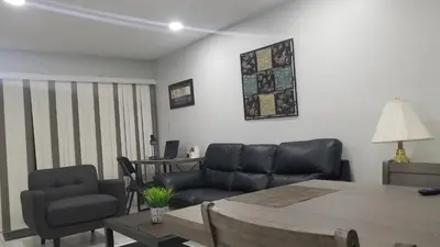 a living room with a couch and a table and chairs at 3697 Orlando Vacational Apartment in Orlando