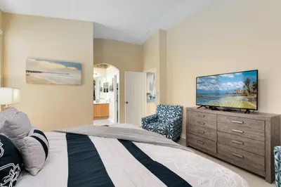 a bedroom with a bed and a flat screen tv at Amazing Disney Dream Getaway in Windsor Palms! villa in Kissimmee