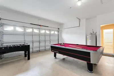 a garage with a ping pong table and a pool table at Amazing Disney Dream Getaway in Windsor Palms! villa in Kissimmee