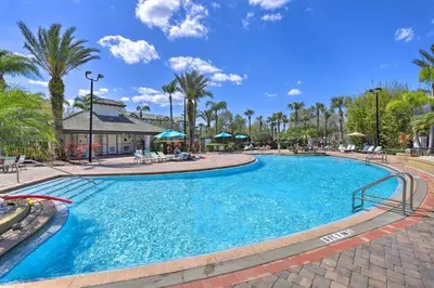 a swimming pool at a resort with palm trees at NEW! Luxury Condo, Min to DisneyConvention Center in Orlando
