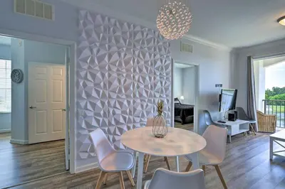 a living room with a table and chairs at NEW! Luxury Condo, Min to DisneyConvention Center in Orlando