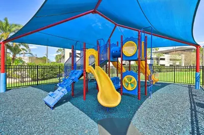 a playground with a slide and a blue canopy at NEW! Luxury Condo, Min to DisneyConvention Center in Orlando