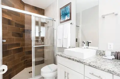 a bathroom with a toilet and a sink and a shower at Stylish Family Villa 5min Disney BBQ 1804ft in Orlando