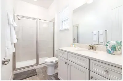 a white bathroom with a shower and a toilet at ZAY & ZAC’S SHAKE SHACK in Orlando