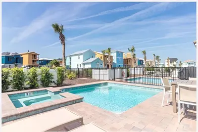 a swimming pool with a table and chairs and houses at ZAY & ZAC’S SHAKE SHACK in Orlando