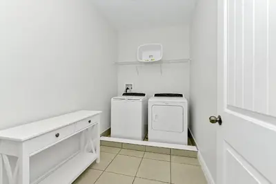 a white laundry room with two washer and dryer at Marvelous Home Near Disney With Private Pool And Waterpark & Resort Access At Encore Resorts Reunion - 250Cl in Kissimmee