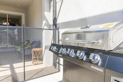 a grill sitting on top of a balcony at Storey Lake Pool Mins to Disney 4BR Games in Kissimmee
